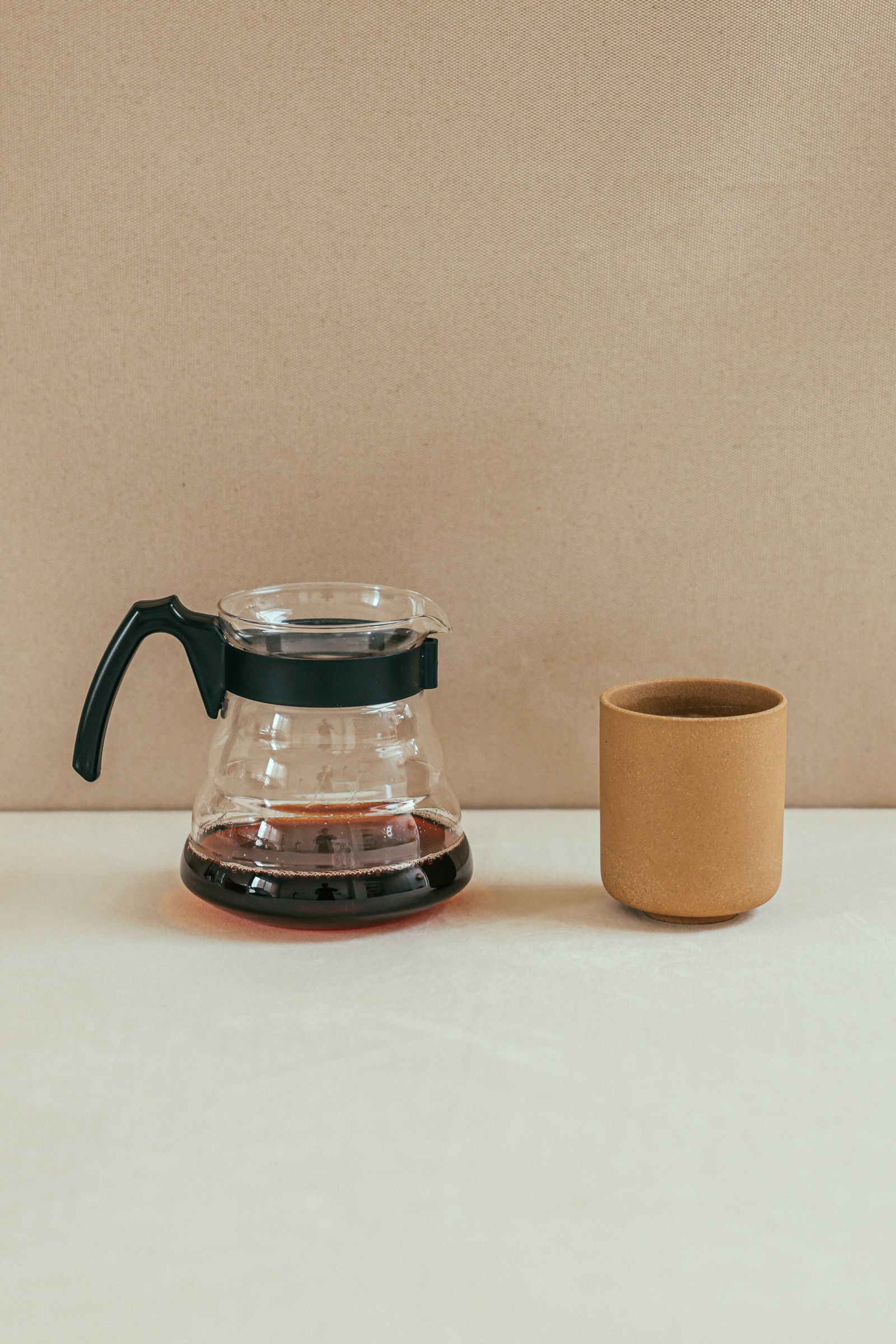 A pour-over coffee setup with a dripper and glass server